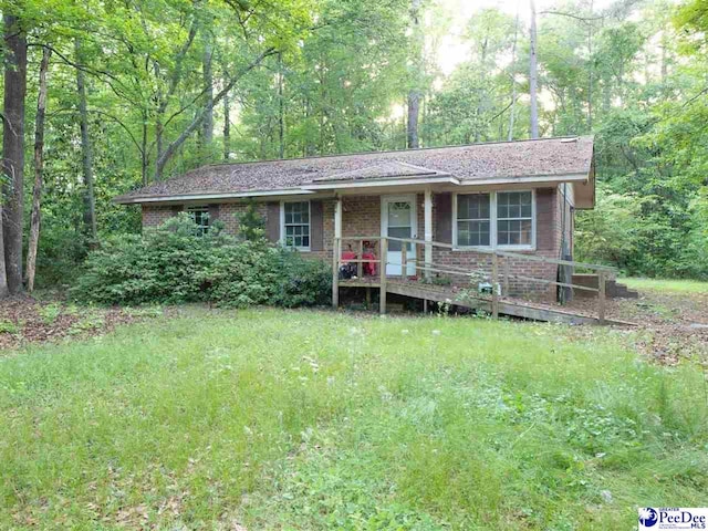 3121 Spring Valley Dr, Florence, SC 29501 - single story home with covered porch, brick siding, and a view of trees