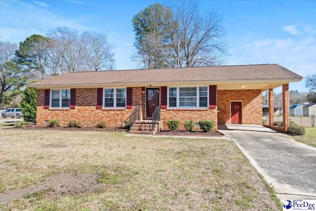 ranch-style house with an attached carport, driveway, brick siding, and a front lawn