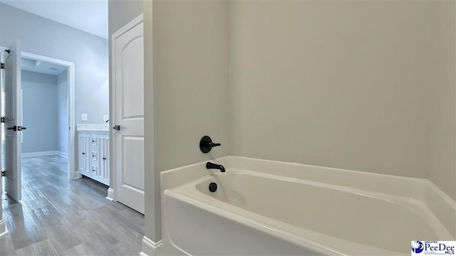 bathroom featuring hardwood / wood-style flooring and a washtub