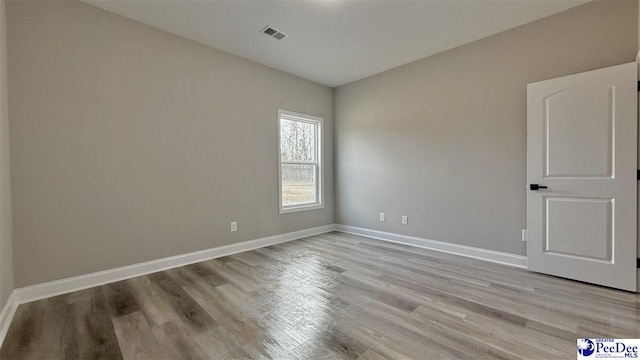 empty room with light hardwood / wood-style floors