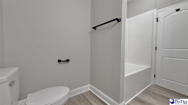 bathroom featuring wood-type flooring and toilet