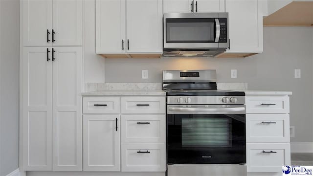 kitchen with white cabinets and appliances with stainless steel finishes