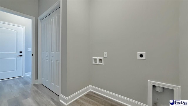 clothes washing area with hookup for an electric dryer, hookup for a washing machine, and light hardwood / wood-style flooring