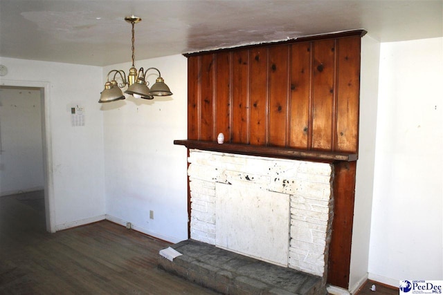 unfurnished dining area featuring an inviting chandelier and dark hardwood / wood-style flooring