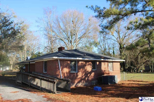 view of property exterior featuring a wooden deck and cooling unit