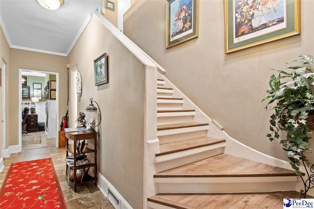 stairway featuring crown molding