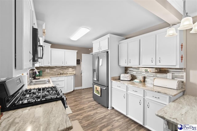 kitchen with sink, white cabinetry, decorative light fixtures, dark hardwood / wood-style floors, and stainless steel appliances