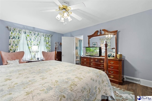 bedroom with dark hardwood / wood-style floors and ceiling fan