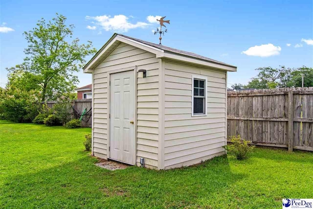 view of outbuilding featuring a lawn