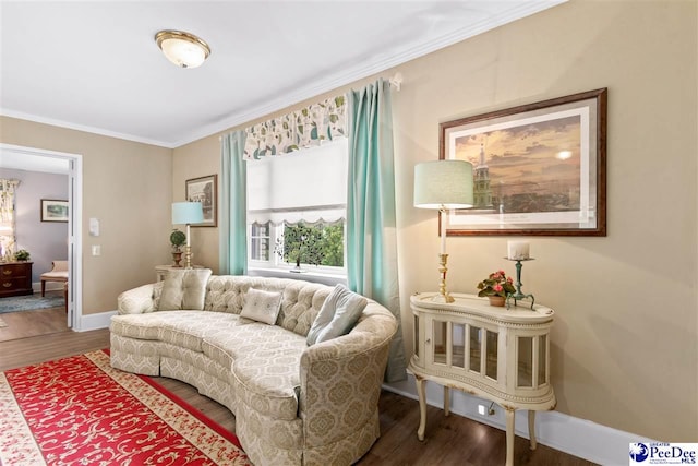 sitting room featuring ornamental molding and dark hardwood / wood-style flooring