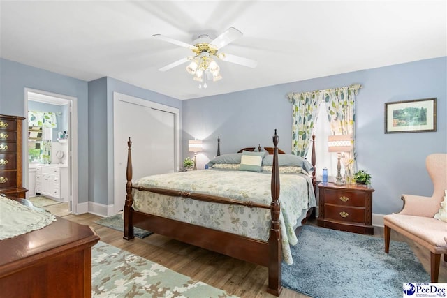 bedroom featuring ceiling fan, ensuite bathroom, light hardwood / wood-style floors, and a closet