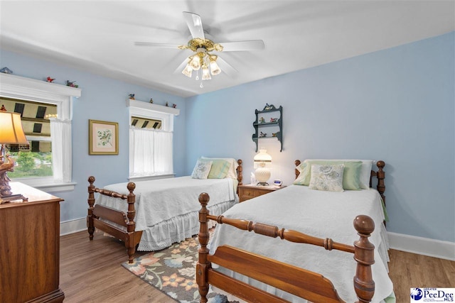 bedroom with ceiling fan and light hardwood / wood-style floors