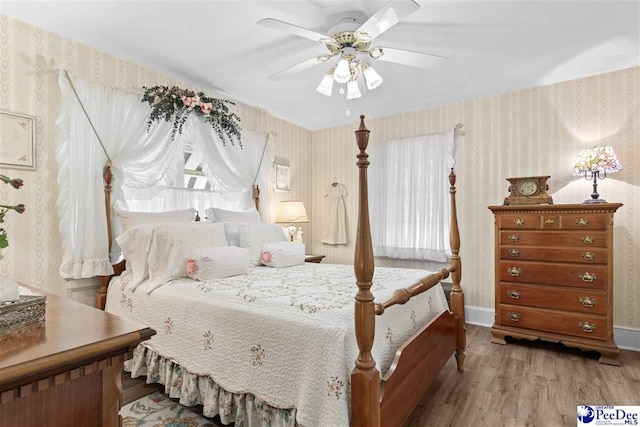 bedroom featuring light hardwood / wood-style flooring and ceiling fan