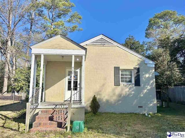 view of property exterior with crawl space, fence, and a lawn