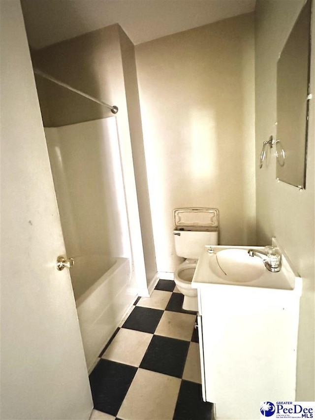 bathroom featuring shower / bathtub combination, vanity, toilet, and tile patterned floors