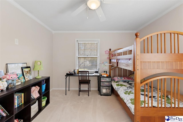 carpeted bedroom featuring a ceiling fan, baseboards, and crown molding