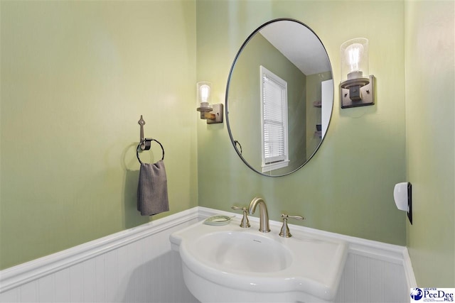 bathroom with a sink and wainscoting