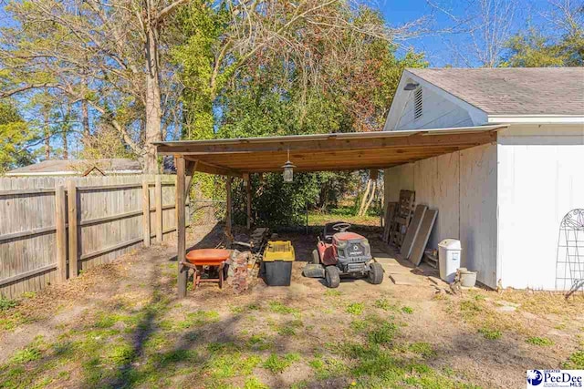 exterior space with a carport, fence, and driveway