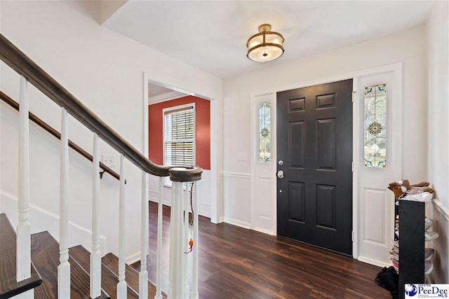 foyer entrance with dark wood-style flooring and stairway