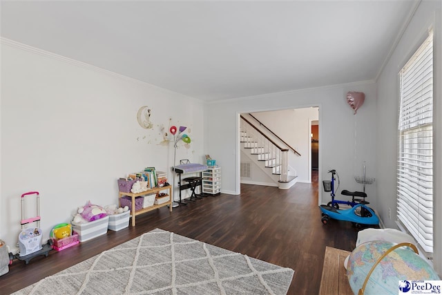 rec room with crown molding, visible vents, and wood finished floors