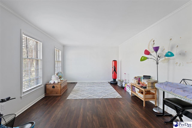 interior space featuring ornamental molding, baseboards, and wood finished floors