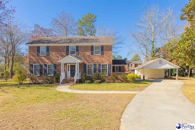 colonial house with concrete driveway, brick siding, and a front lawn