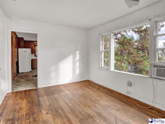 515 W Darlington St, Florence, SC 29501 - empty room with cooling unit, baseboards, and wood-type flooring
