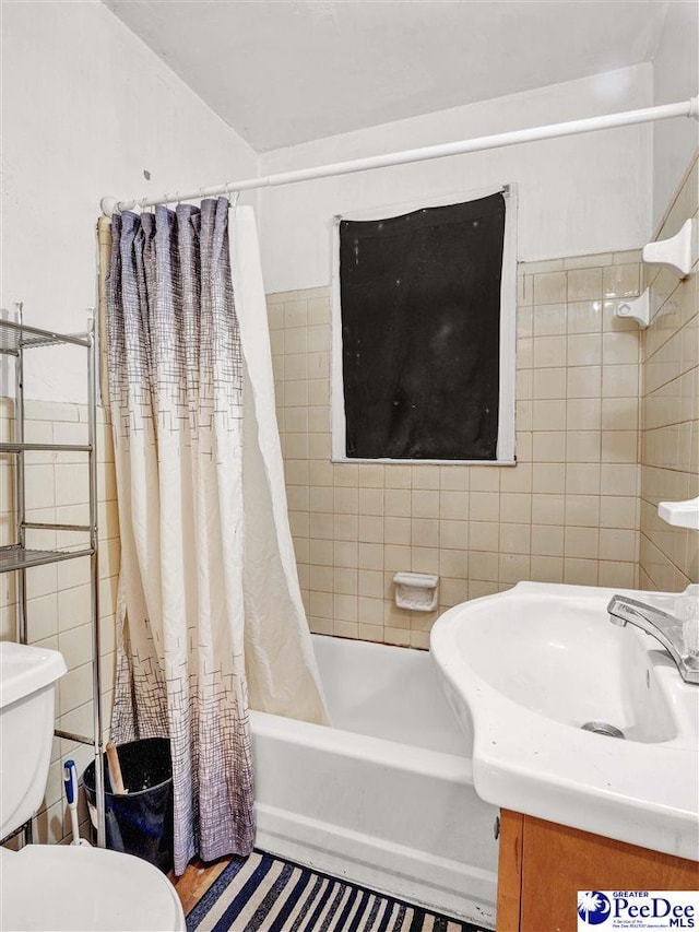 515 W Darlington St, Florence, SC 29501 - bathroom featuring vanity, tile walls, toilet, and shower / bathtub combination with curtain