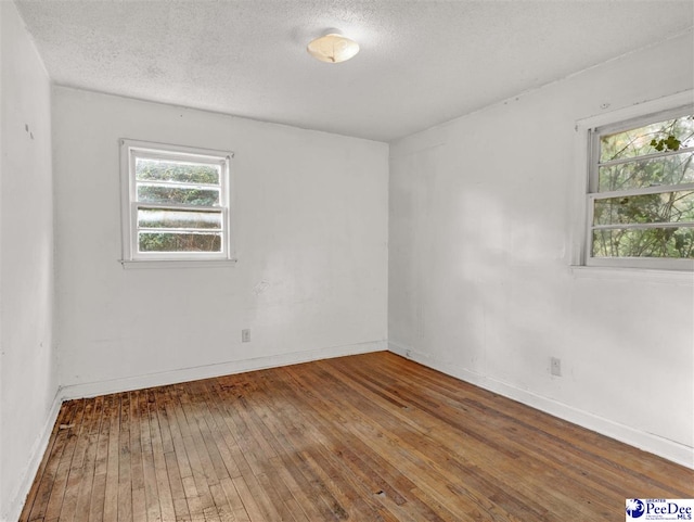 515 W Darlington St, Florence, SC 29501 - empty room featuring baseboards, a textured ceiling, and hardwood / wood-style flooring