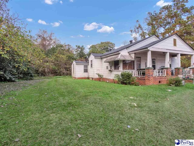515 W Darlington St, Florence, SC 29501 - view of property exterior with a lawn and covered porch
