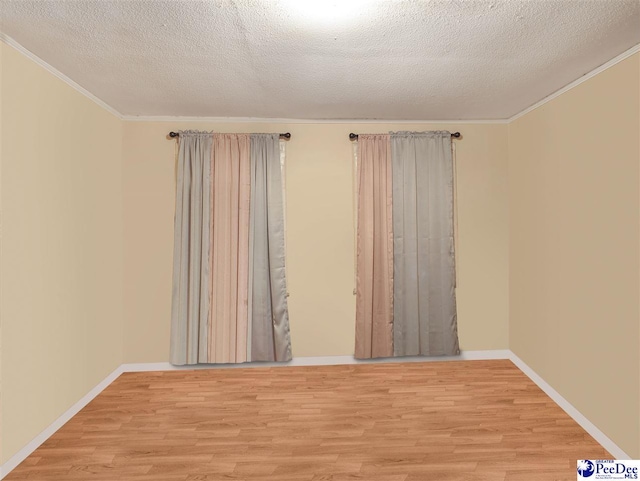 515 W Darlington St, Florence, SC 29501 - unfurnished room with baseboards, a textured ceiling, light wood-style flooring, and crown molding