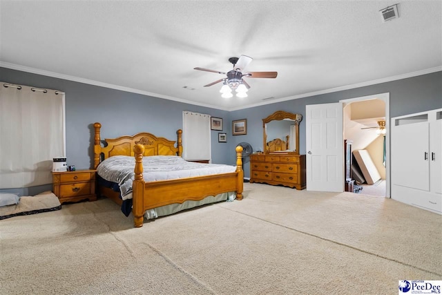 bedroom featuring visible vents, ceiling fan, ornamental molding, a textured ceiling, and carpet flooring