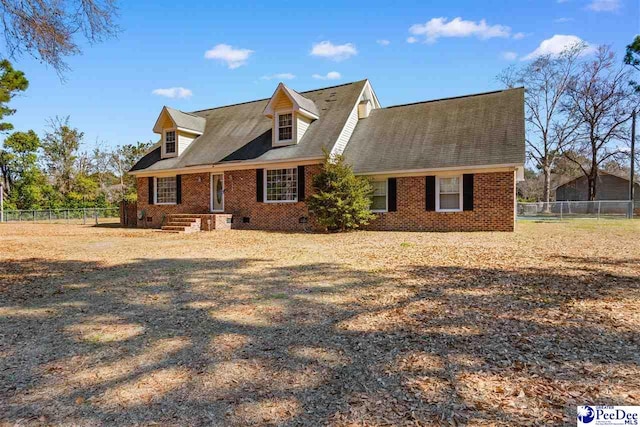 cape cod house featuring crawl space, fence, and brick siding