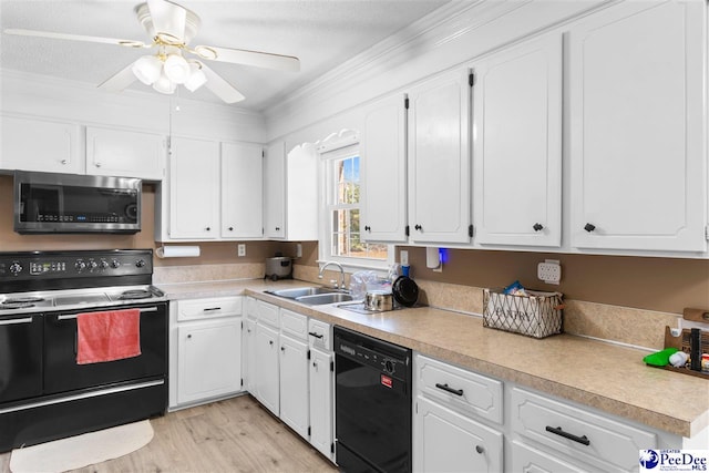 kitchen featuring white cabinetry, a sink, and black appliances