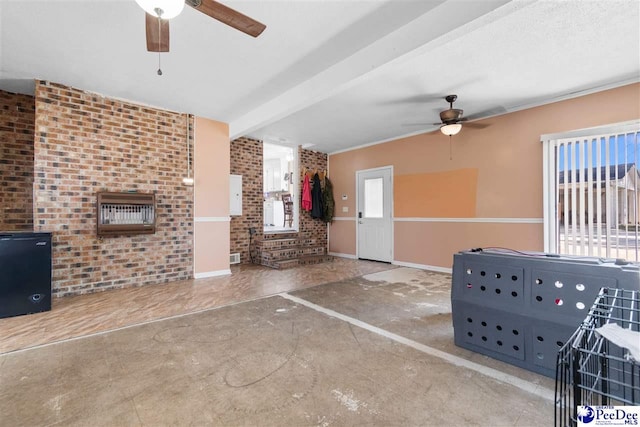 interior space with a ceiling fan and baseboards