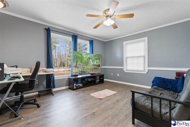 office featuring ornamental molding, a ceiling fan, a textured ceiling, wood finished floors, and baseboards