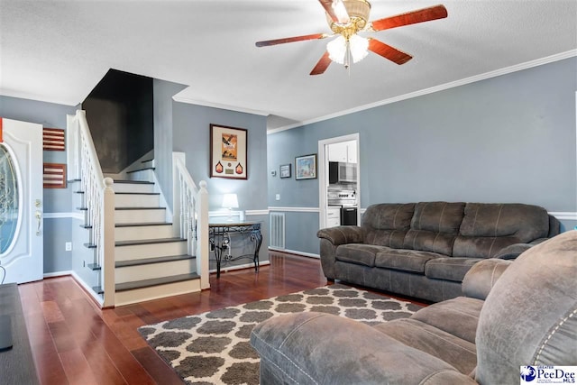 living area with wood finished floors, visible vents, a ceiling fan, ornamental molding, and stairway