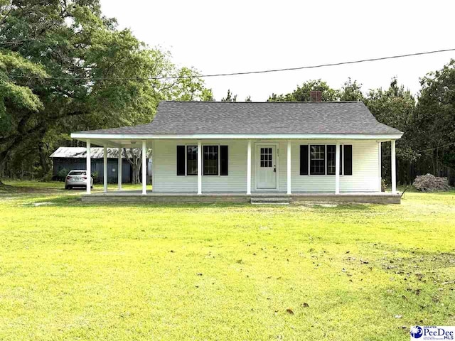 251 Papermill Rd, Florence, SC 29506 - view of front facade featuring covered porch, a front lawn, a carport, and a chimney
