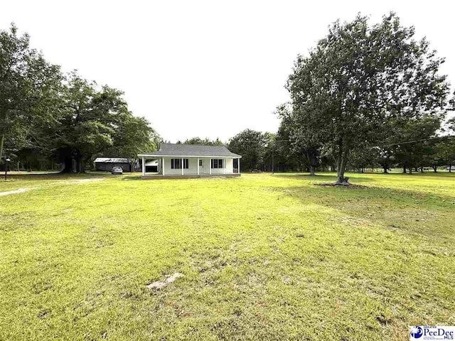 251 Papermill Rd, Florence, SC 29506 - view of green lawn featuring view of wooded area