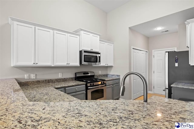 121 Parmelee Dr, Murrells Inlet, SC 29576 - kitchen with stainless steel appliances, light stone countertops, and white cabinets