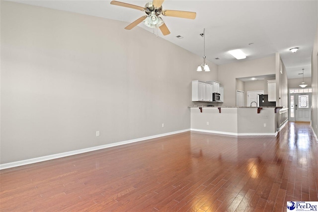 121 Parmelee Dr, Murrells Inlet, SC 29576 - unfurnished living room with ceiling fan, wood finished floors, and high vaulted ceiling