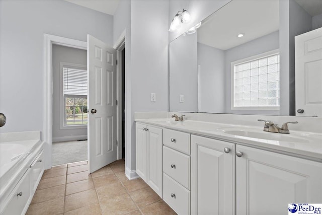 full bathroom featuring a garden tub, double vanity, a sink, and a wealth of natural light
