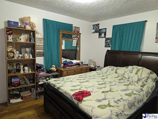 2351 Millers Rd, Mullins, SC 29574 - bedroom featuring dark wood-style flooring and a textured ceiling