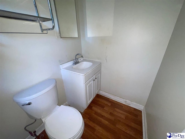2990 Shadeland Cir, Florence, SC 29501 - bathroom with vanity, wood finished floors, and toilet