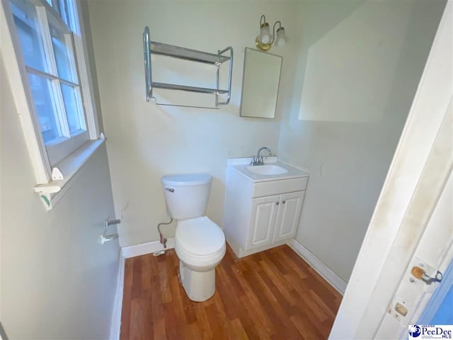 2990 Shadeland Cir, Florence, SC 29501 - half bathroom with toilet, wood finished floors, vanity, and baseboards