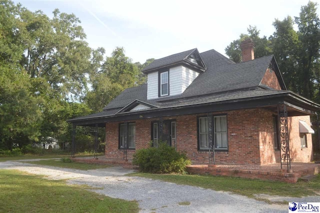 view of front of house featuring a front yard and covered porch