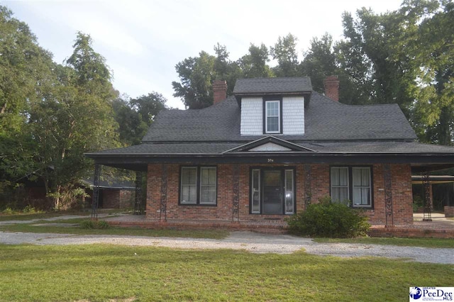 view of front facade with a front lawn and a porch