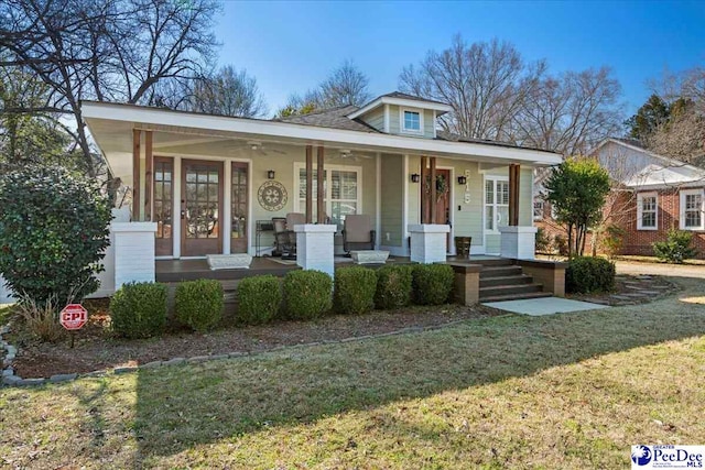 bungalow featuring covered porch and a front lawn