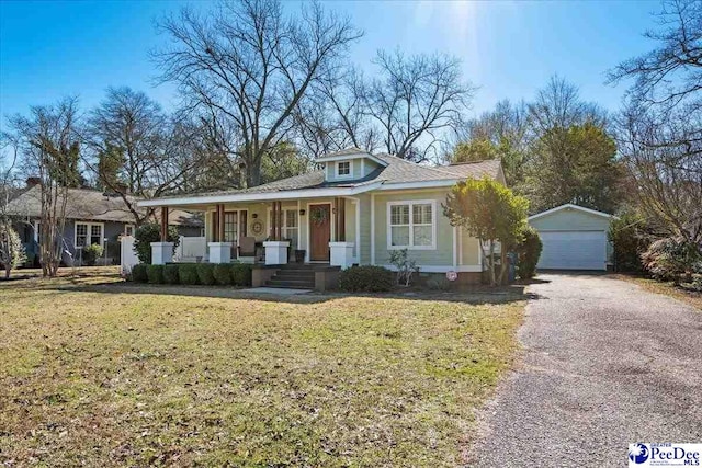 view of front facade with covered porch, an outdoor structure, a garage, and a front yard