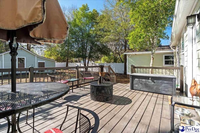 wooden terrace with a fire pit